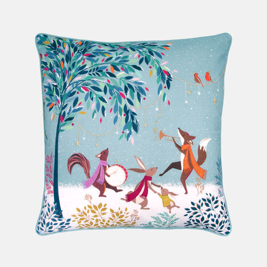 Decorative festive cushion with woodland animals in merry band illustration on a light blue background.