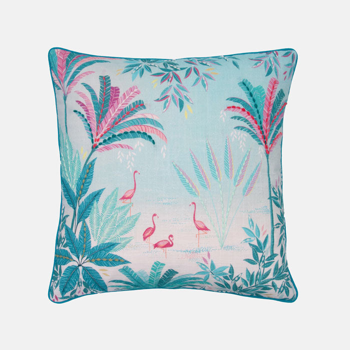 Decorative cushion with flamingo and tropical leaf pattern on a light blue background