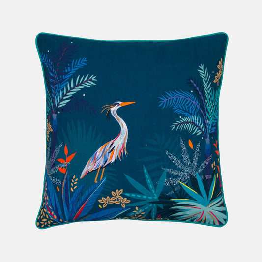 Decorative cushion with a heron and tropical leaves design on a teal background