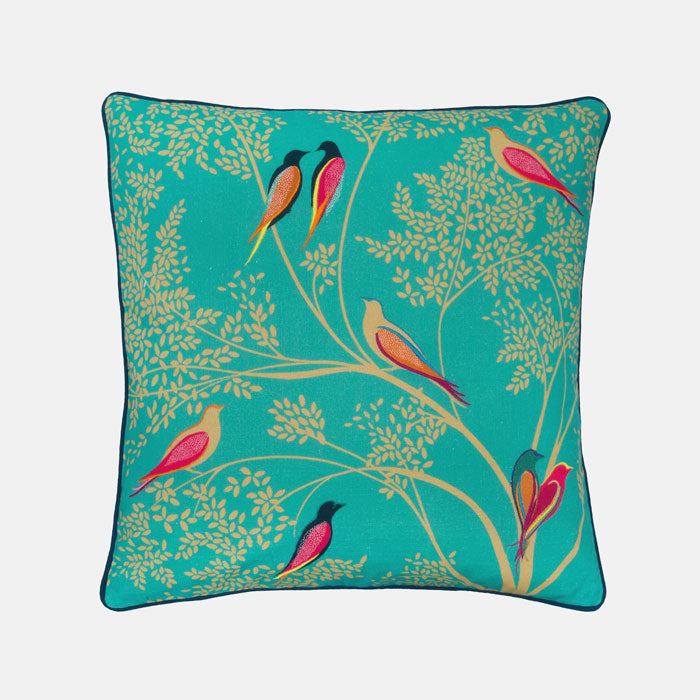 Decorative cushion with bird and branch pattern on a green background