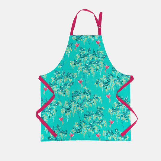 Green apron with pink straps and hummingbird and foliage design.