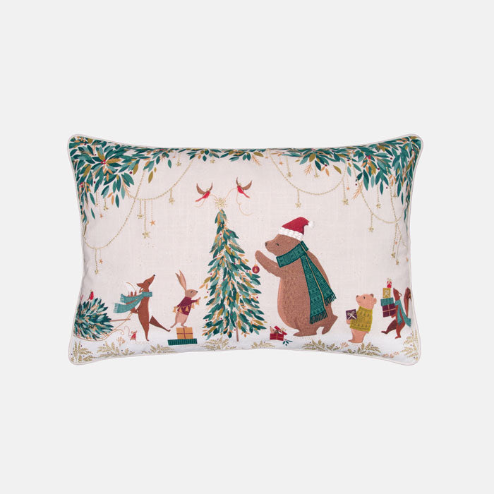 Festive decorative cushion with bear and woodland animals decorating the Christmas tree on a cream background
