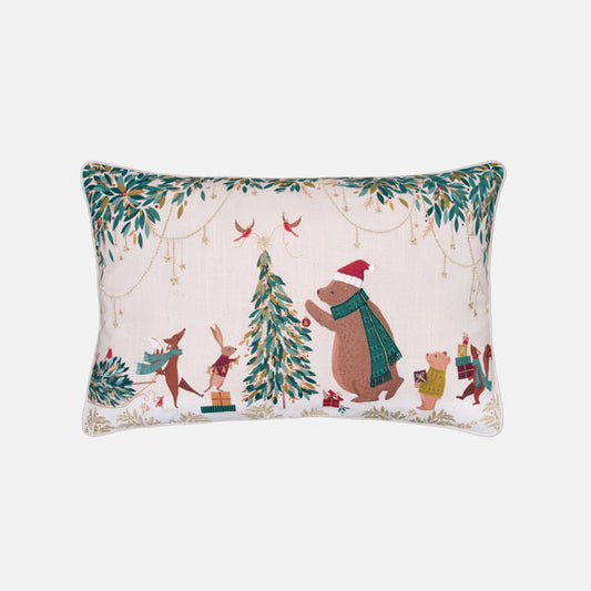 Festive decorative cushion with bear and woodland animals decorating the Christmas tree on a cream background