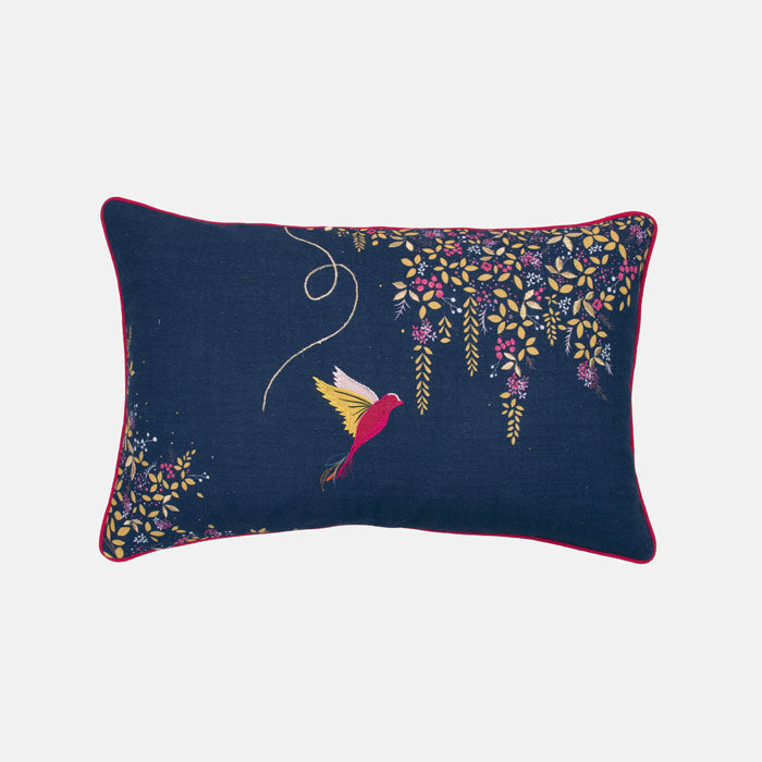 Decorative cushion with hummingbird and floral design on a navy background