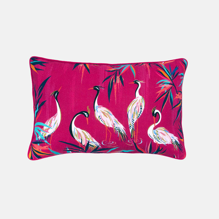 Decorative cushion with heron and bamboo pattern on a pink background