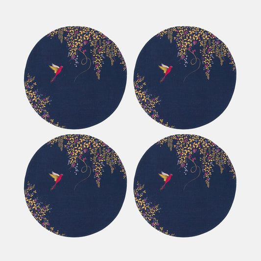 Set of four identical round placemats with floral and bird design on a dark blue background