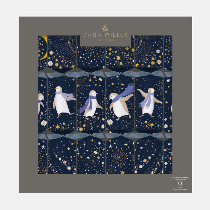 A box of dark blue Christmas crackers with penguin and starry night design.