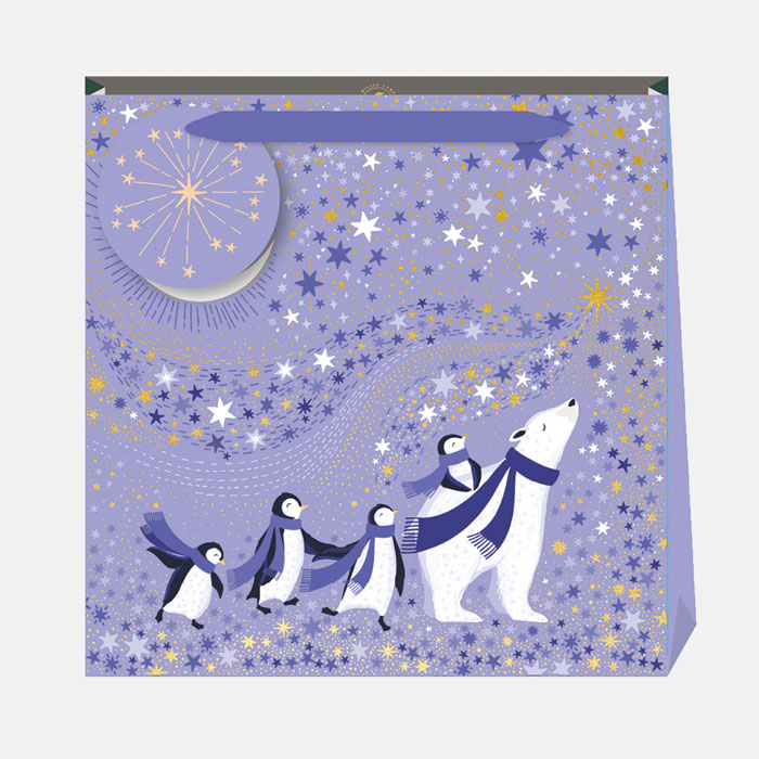 A periwinkle Christmas gift bag with penguins and a polar bear against a starry sky.
