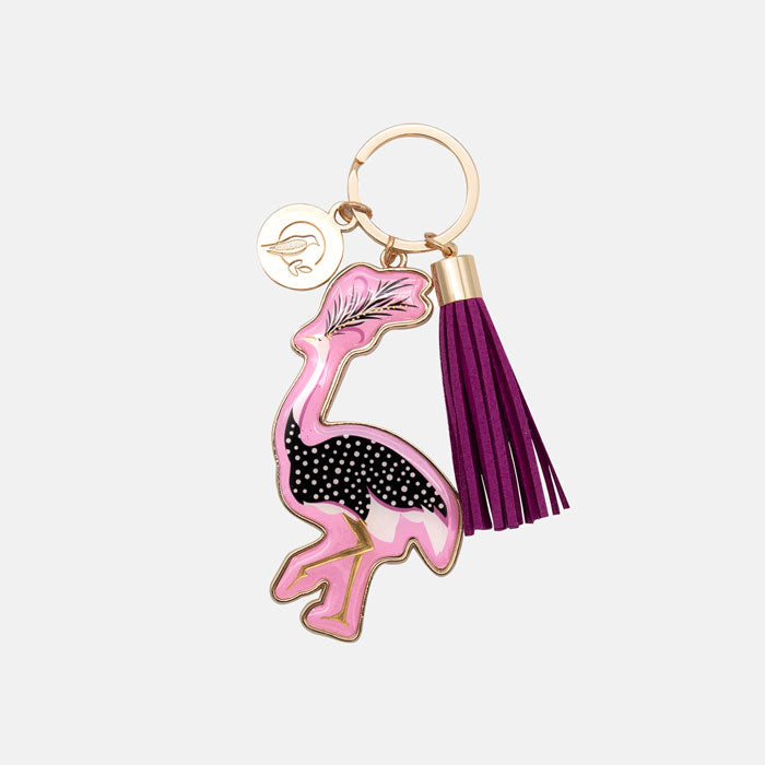 Keychain with flamingo design and purple tassel on a light gray background