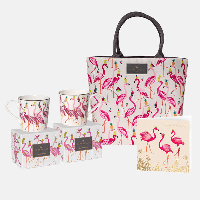 Flamingo-patterned tote bag, mugs, and birthday card on a white background