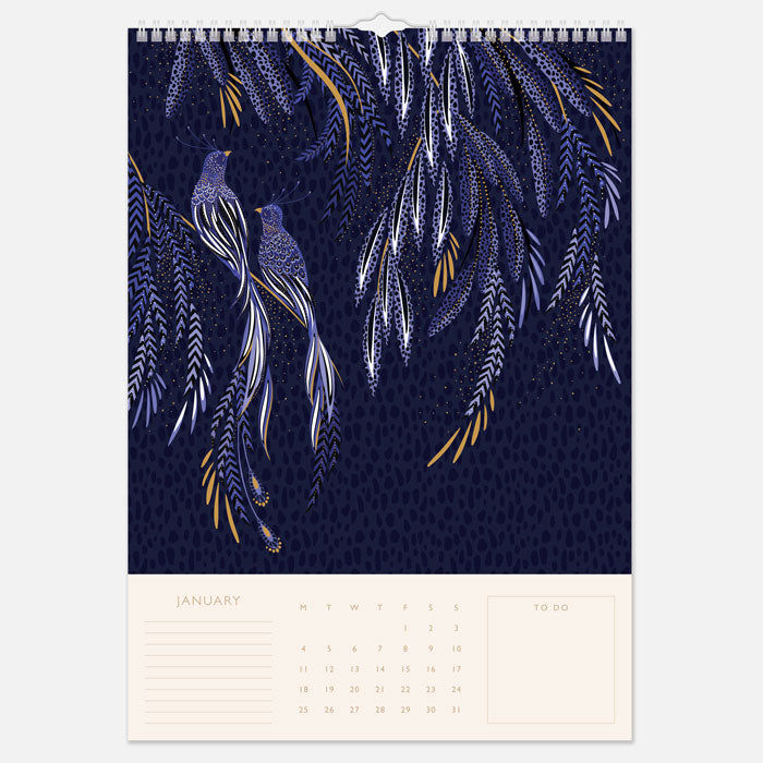A hanging spiral bound wall calendar with intricate designs, one month per page view.