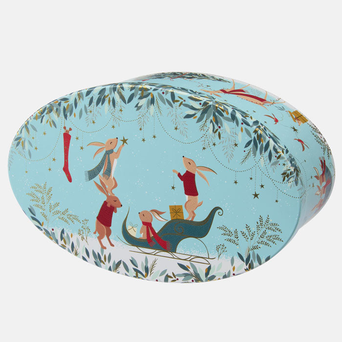 Decorative oval tin with festive rabbit design on a light blue background