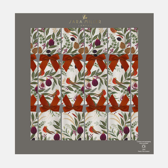 A box of cream Christmas crackers with festive foliage, figs and robins finished with red ribbons.