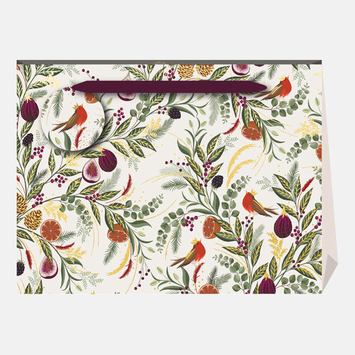 A Christmas present bag with winter foliage, figs and robins on a cream backdrop, with a matching gift tag and ribbon handles.