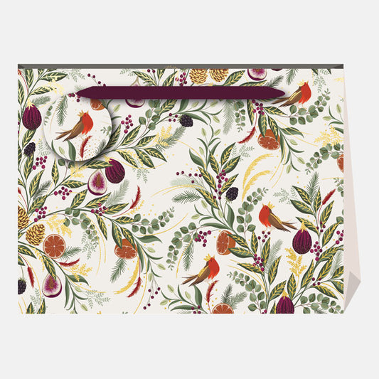 A Christmas present bag with winter foliage, figs and robins on a cream backdrop, with a matching gift tag and ribbon handles.
