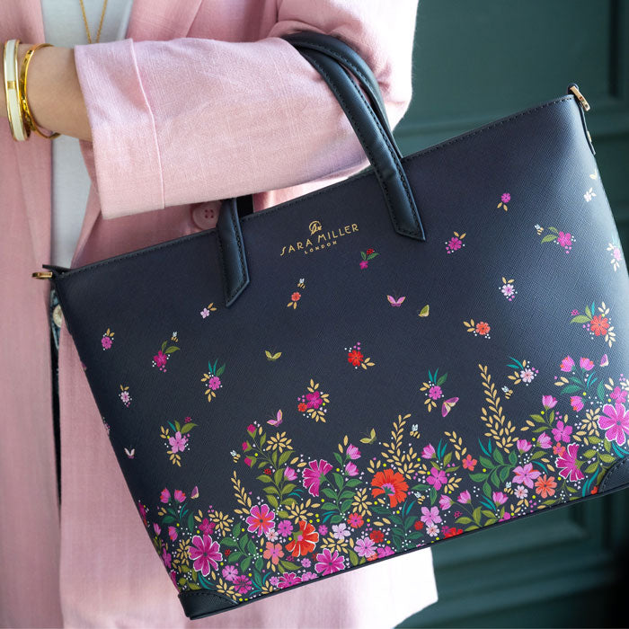 Model wearing ditsy floral medium tote bag. Can see length of straps and scale.
