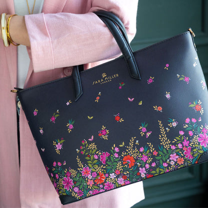 Model wearing ditsy floral medium tote bag. Can see length of straps and scale.