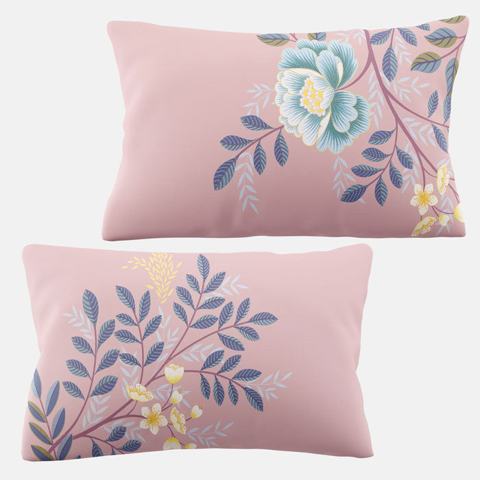 Two pink pillows with floral patterns on a white background