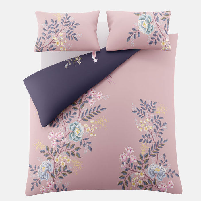 Floral patterned bedding set with pink and navy colours on a white background