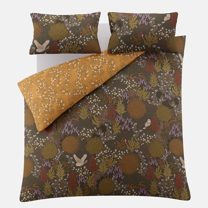 Floral and bird patterned bedding set on a white background