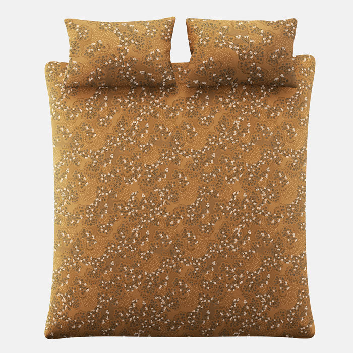 Yellow ochre patterned bedding set with two pillows on a white background