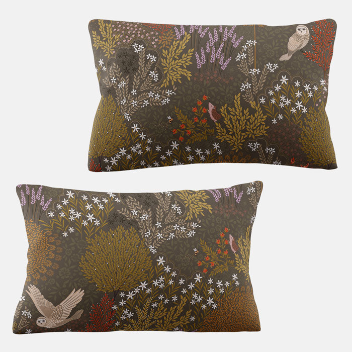 Two decorative pillows with foliage patterns on a white background