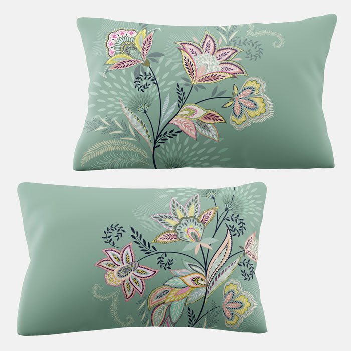 Two green pillows with floral pattern on a white background
