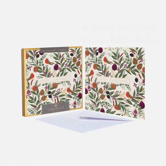 A set of illustrated luxury greeting cards and envelopes featuring a festive foliage and fruits pattern on a cream background, in shades of green, red and plum with gold embellishment.