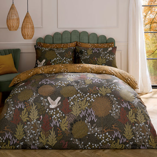 Bed with floral patterned duvet cover in a room with a window and decorative pillows.