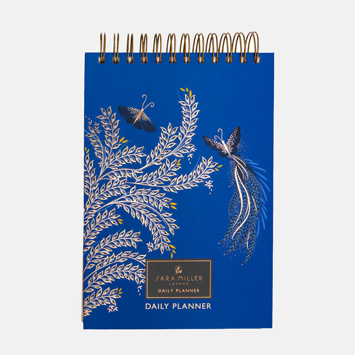 Blue daily planner with butterfly design on a cobalt blue background.