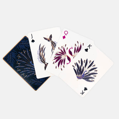 Playing cards with peacock feathers design on an indigo background.