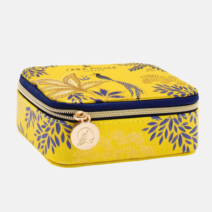 Yellow wellness organiser with botanic and bird design, and gold detailing. Shows embossed zip pull detail with Sara Miller London logo.