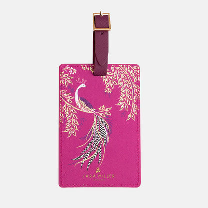 Fuchsia luggage tag with elegant bird design and gold detailing, buckle fastening.