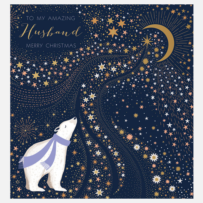 A square Christmas greeting card with a  polar bear wearing a purple scarf, gazing upward at a starry night sky. The card includes a gold crescent moon, many stars in white and gold, and the text 'TO MY AMAZING Husband MERRY CHRISTMAS' in the upper left.