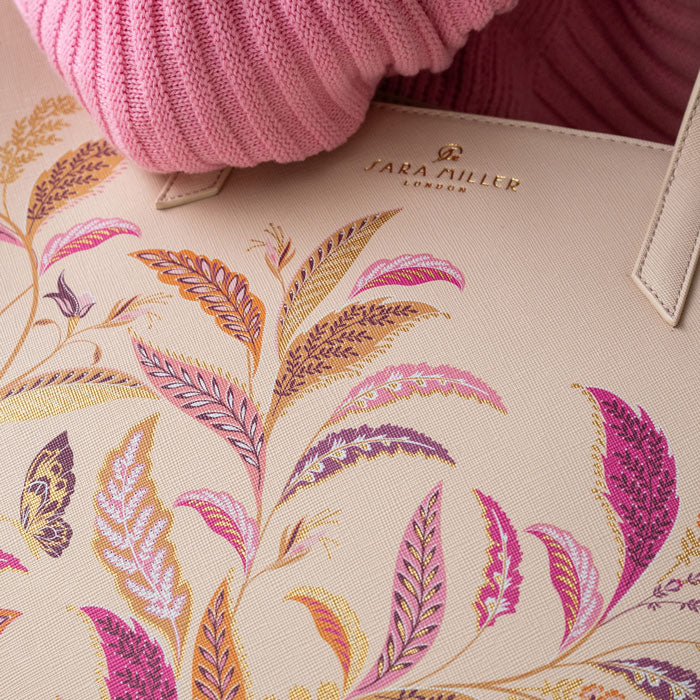 Close up of floral pattern on bag, can see Sara Miller London gold embossed logo.