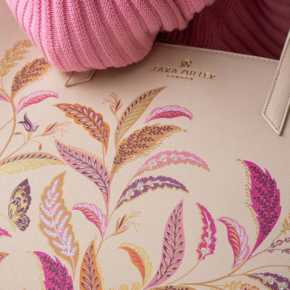 Close up of floral pattern on bag, can see Sara Miller London gold embossed logo.