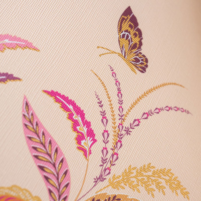 Close up of design on bag, shows gold detailing and handbag texture.