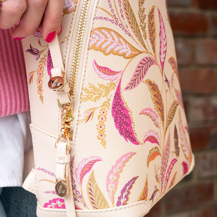 Close up of gold zips with etched Sara Miller London logo detail.