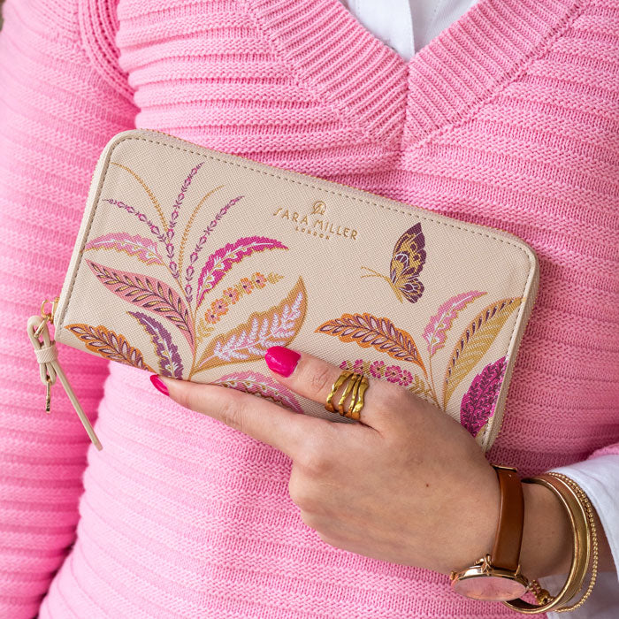 Someone holding the purse.