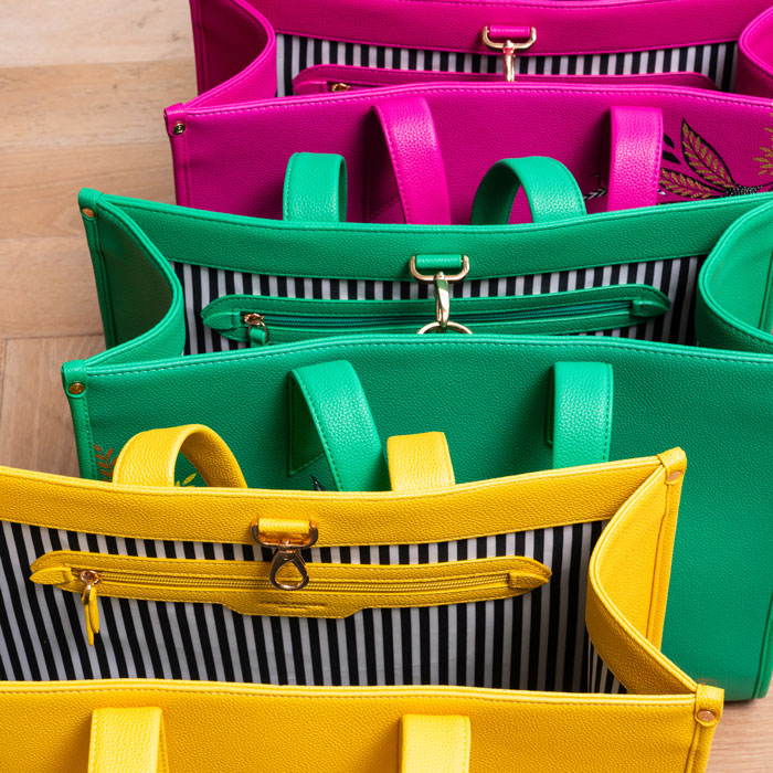 Bags from the same collection together, in yellow, green and pink.