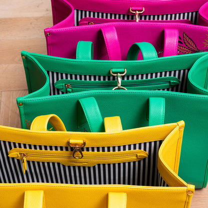 Bags from the same collection together, in yellow, green and pink.