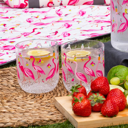 Two clear plastic cups with flamingo design, full of water with lemon slices.
