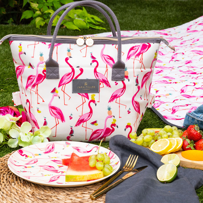 Flamingo-patterned bag with a picnic setup on grass