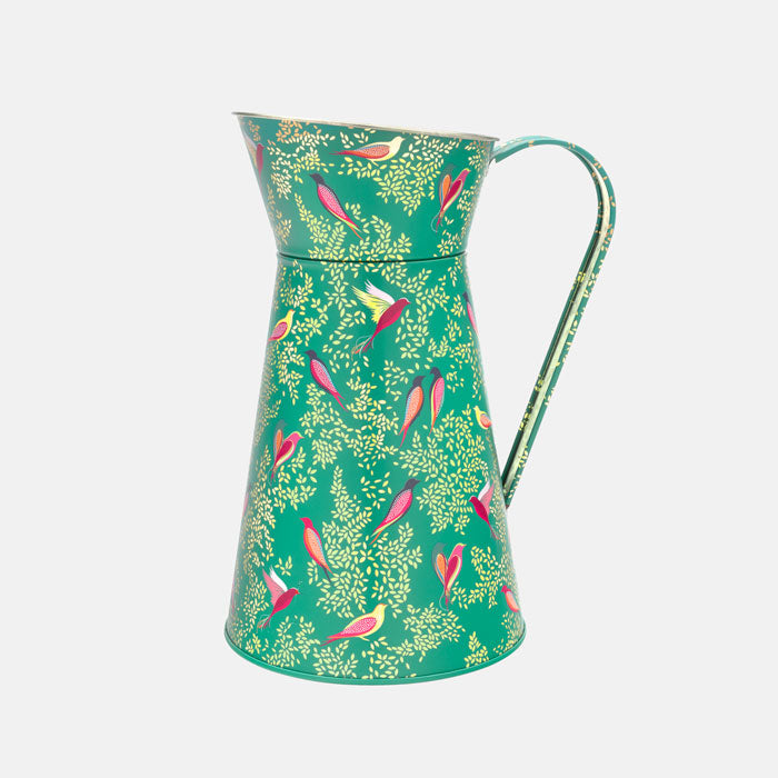 A green tin flower jug with little colourful birds perched among delicate foliage, with gold embellishment. 