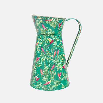 A green tin flower jug with little colourful birds perched among delicate foliage, with gold embellishment. 