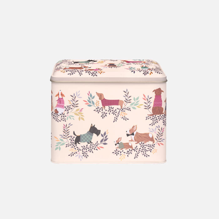 Tin storage container with cute dog design and foliage, light beige base.