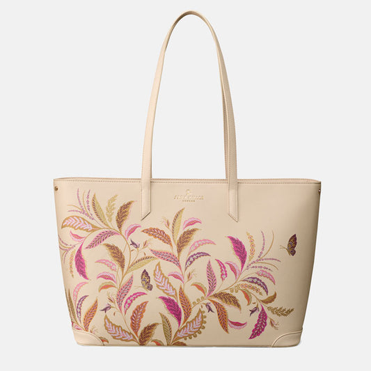 Cream tote style handbag with floral pattern on a white background.