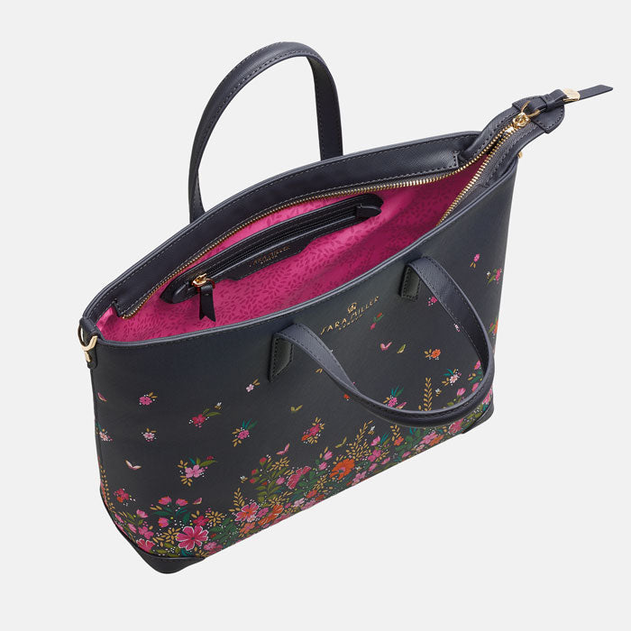 Ditsy floral medium tote bag with delicate floral design, white background. Can see inside pink lining and zip pocket.