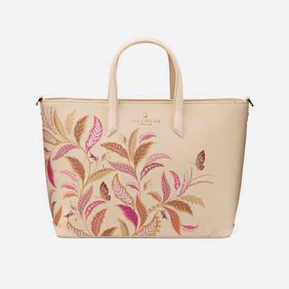 Cream tote style handbag with floral pattern on a white background
