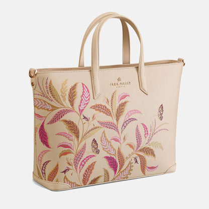 Beige tote style handbag with a floral design.